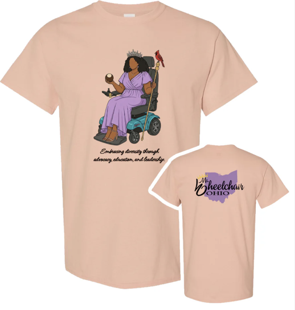 The image shows a peach colored T-shirt with two views: the front and the back. On the front is an illustration of a dark-haired woman wearing a purple dress and a crown, seated in a mobility power wheelchair. She holds a buckeye in one hand and a gold staff in the other. A red cardinal perches on the back of the power wheelchair. Below the illustration, text reads, "Embracing diversity through advocacy, education, and leadership." On the back of the T-shirt, the design features a purple silhouette of the state of Ohio with the words "Ms. Wheelchair Ohio" in stylized black lettering.